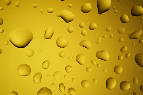 Yellow gold water drops on glass — Stock Photo, Image