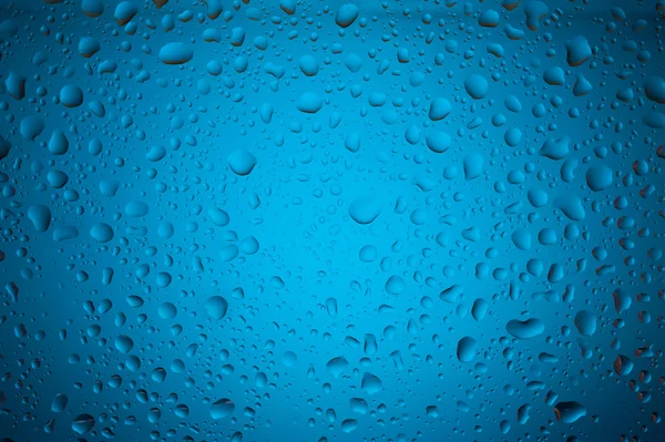 Gotas de agua sobre vidrio azul — Foto de Stock