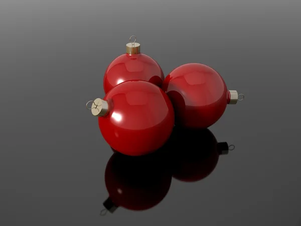 Three christmas balls on a reflective surface — Stock Photo, Image