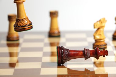 Checkmate with wooden chess pieces clipart