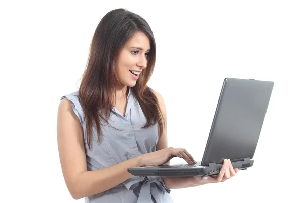 Beautiful woman standing amazed watching a laptop — Stock Photo, Image