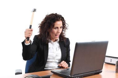 Mature businesswoman trying to destroy a laptop with a hammer clipart
