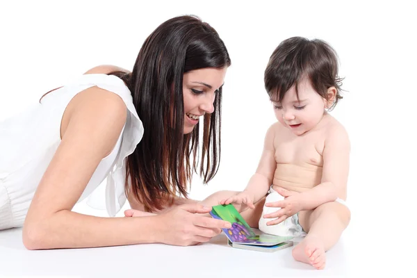 Attractive mother showing a book to her daughter Royalty Free Stock Images