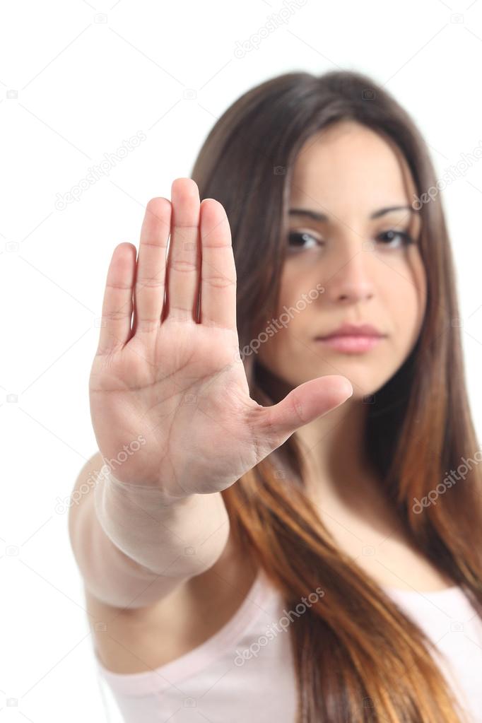 Pretty teenager girl making stop gesture with her hand