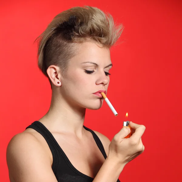 Fashion woman lighting a cigarette Stock Picture