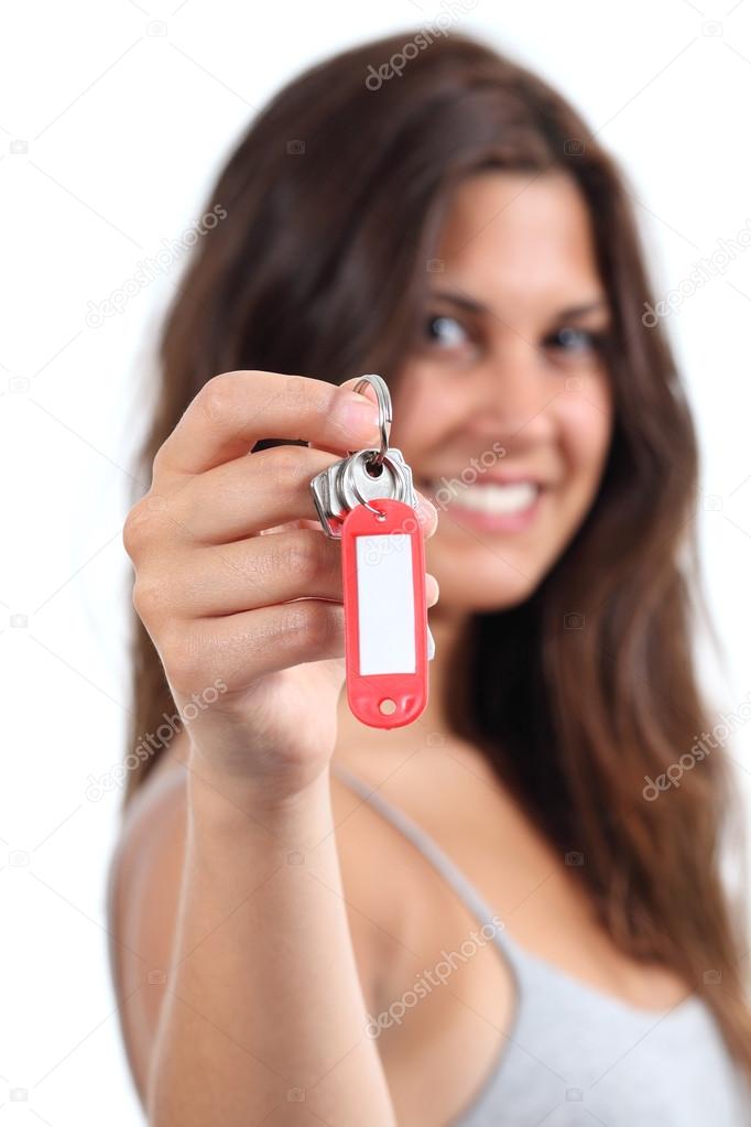 Attractive woman showing a home keys