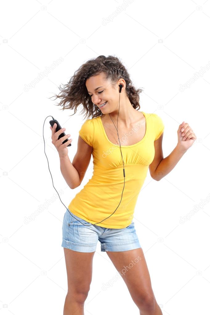 Happy teenager girl dancing and listening to the music