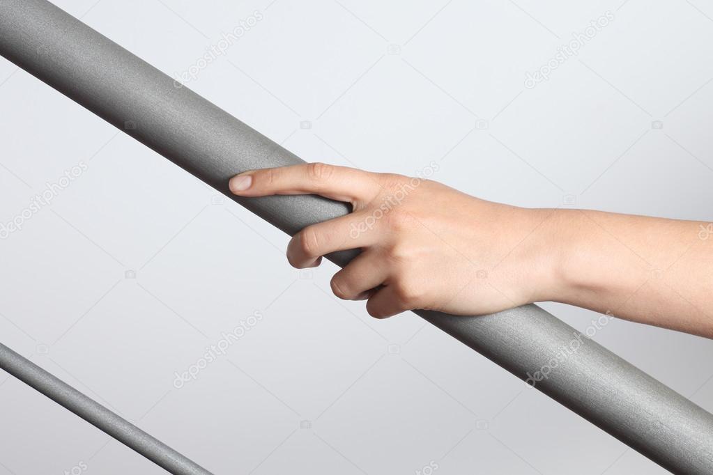 Woman hand using a railing to go upstairs