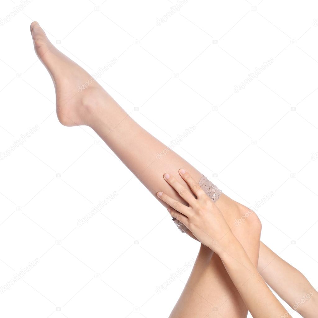 Woman hands putting a stockings on leg