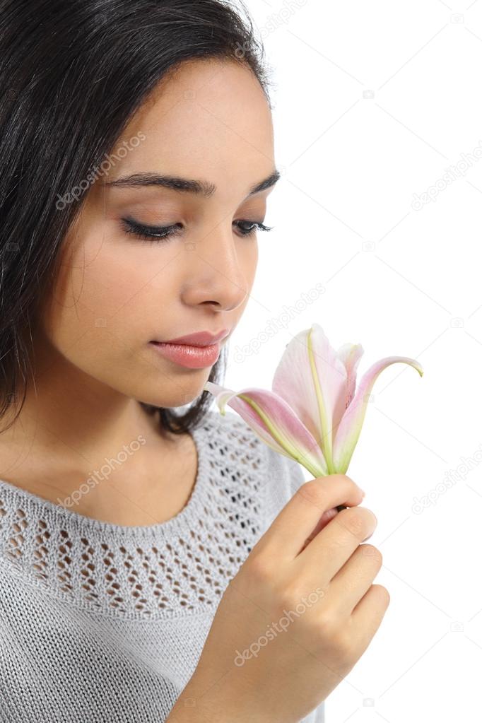 Beautiful arab woman smelling a flower