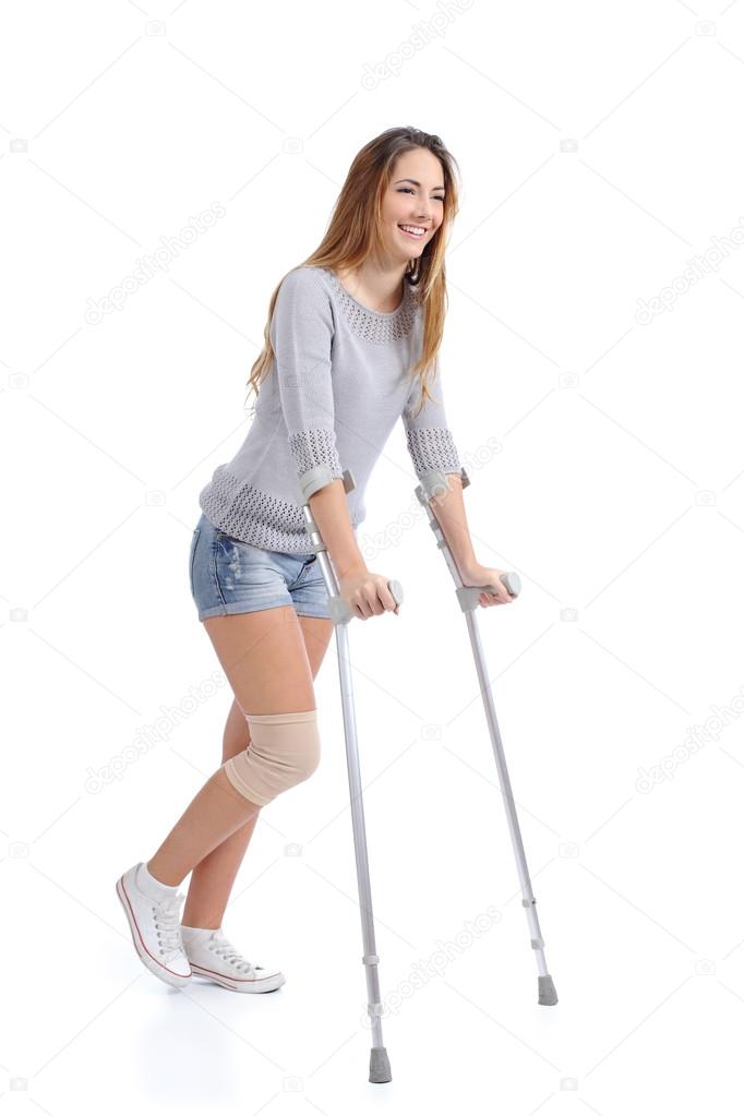 Beautiful woman smiling and hobbling with crutches