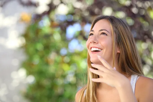 Beautiful woman laughing and looking above — Stock Photo, Image