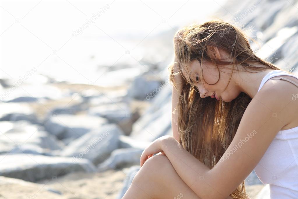 Worried woman on the beach