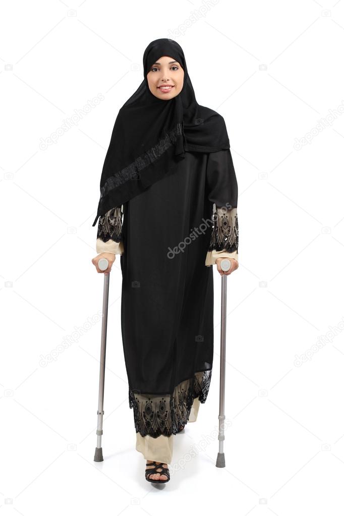 Arab woman walking with crutches