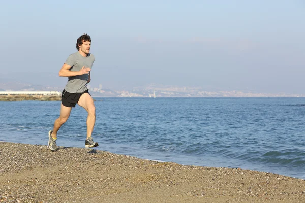 Jogger correndo na praia perto da água — Fotografia de Stock