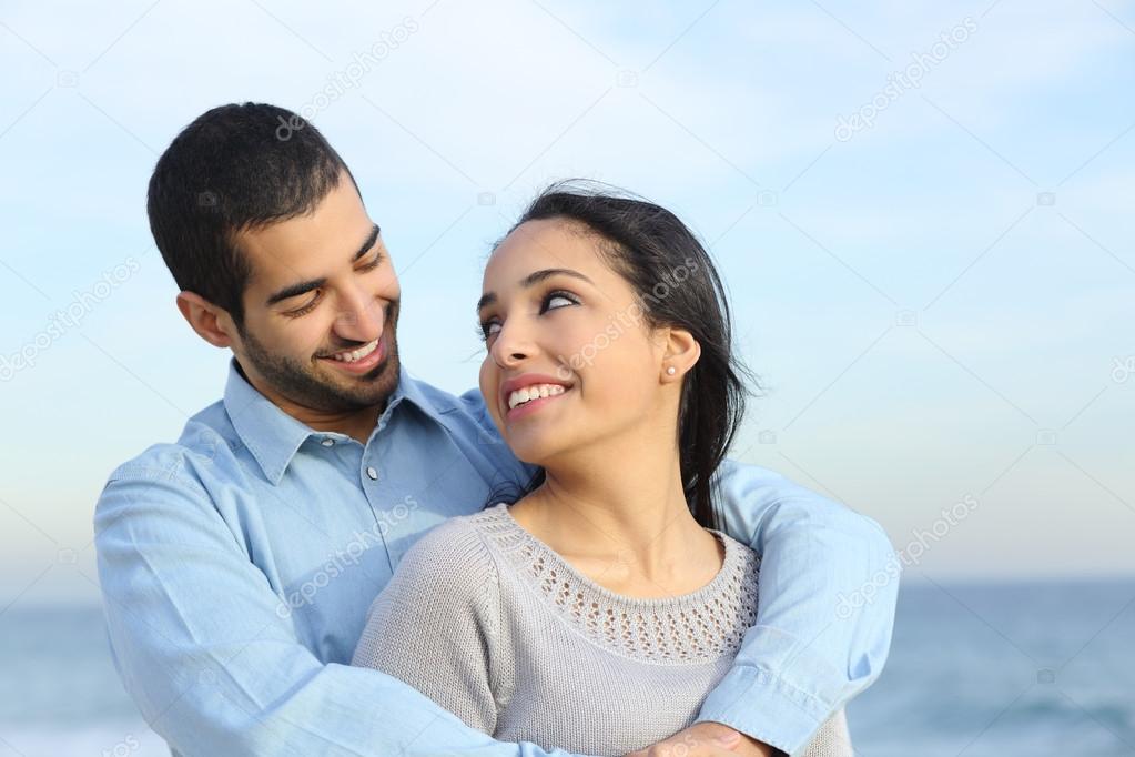 Arab casual couple cuddling happy with love on the beach — Stock Photo