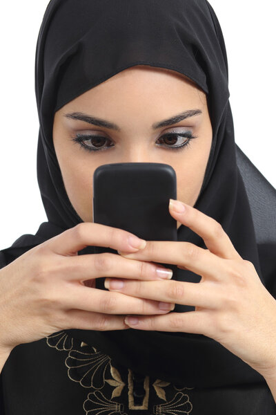 Front view of an arab woman addicted to the smart phone