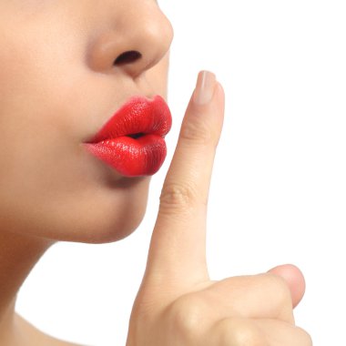 Close up of a woman lips with finger asking for silence