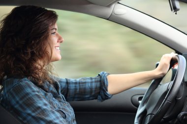 Profile of a happy woman driving a car clipart