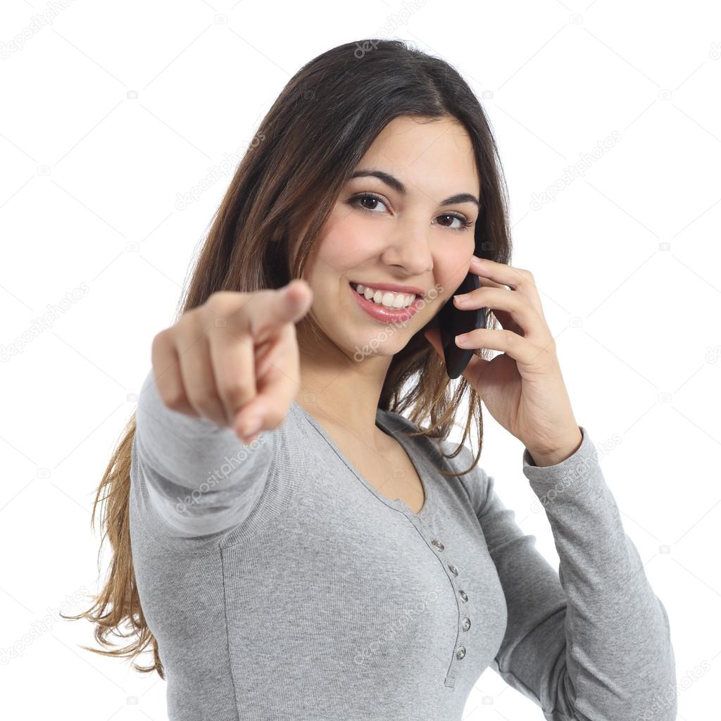Woman pointing at camera calling on the mobile phone