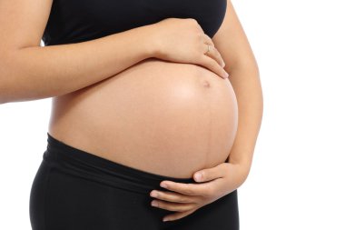 Close up of a belly of a pregnant woman with the hands touching it clipart