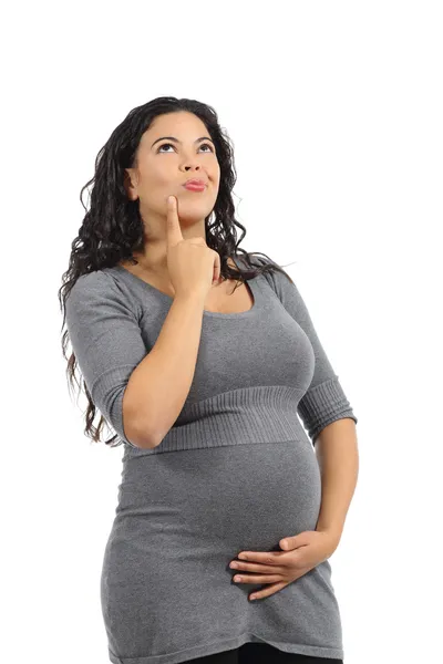 Hermosa mujer embarazada pensando y mirando por encima — Foto de Stock