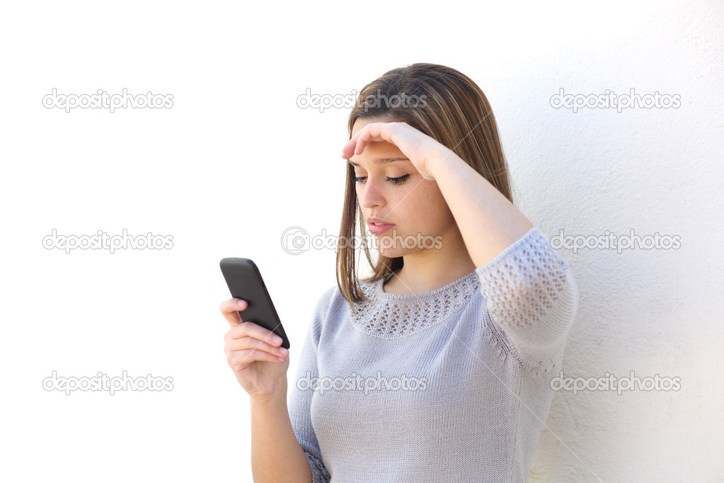 Worried woman looking at the mobile phone