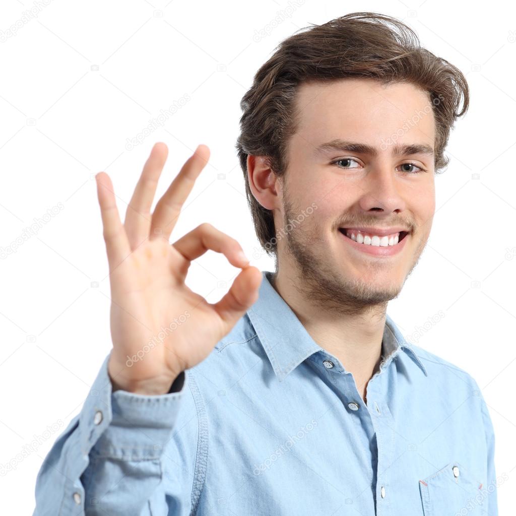 Young happy positive teenager man gesturing ok