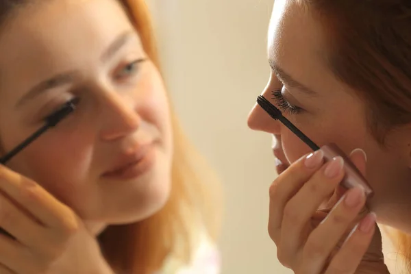 Happy Woman Painting Eyelashes Looking Mirror Bathroom — Stock fotografie