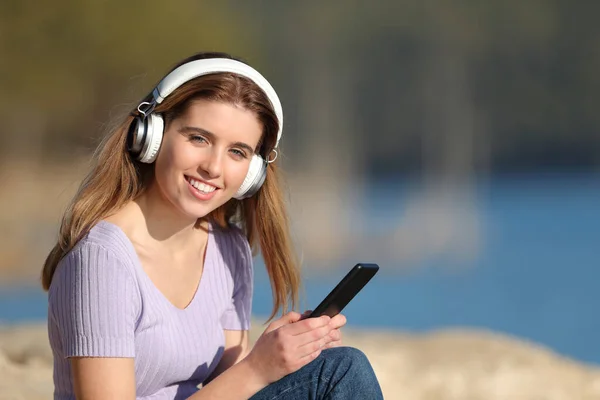 Happy Teen Wearing Headphones Holding Mobile Phone Looks You Listening — Stock Photo, Image