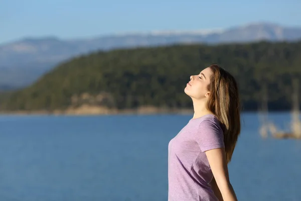 一个满意的少女在湖中呼吸新鲜空气的侧面画像 — 图库照片