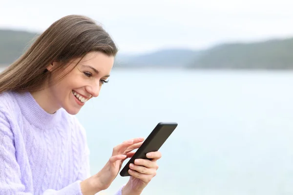 Happy Teenager Checking Mobile Phone Content Sitting Lake — Stock Photo, Image