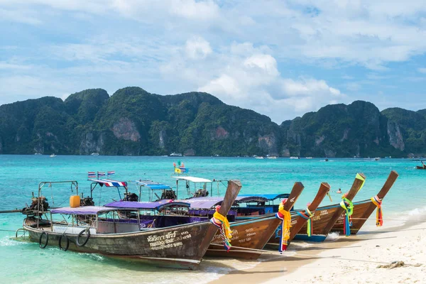 Phi Phi Islands, Thailand, November 2017 - view of some long tail boats harbored in a beach by the afternoon