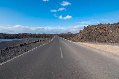 View of a highway at Red Mountain Beach (Playa Montan Bermeja) - Lanzarote, Canary Islands, Spain