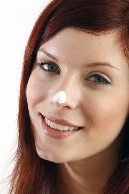 gülümseyen kadın nemlendirici krem burnuna koy.