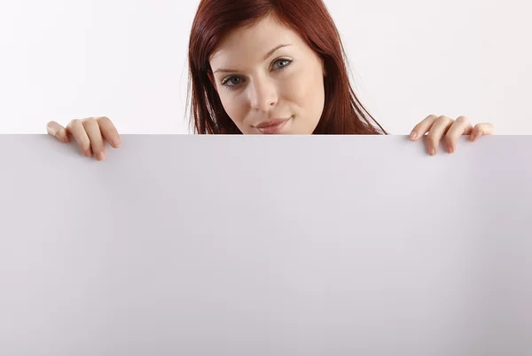 Young woman holding blank sheet — Stock Photo, Image