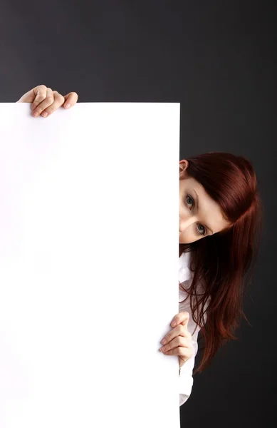 Young woman holding blank sheet — Stock Photo, Image