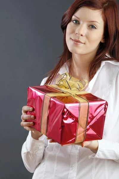 Beautiful young woman with a gift — Stock Photo, Image