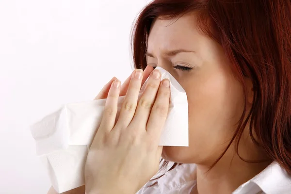 Woman blowing her nose — Stock Photo, Image