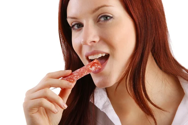 The young woman eat a salami — Stock Photo, Image