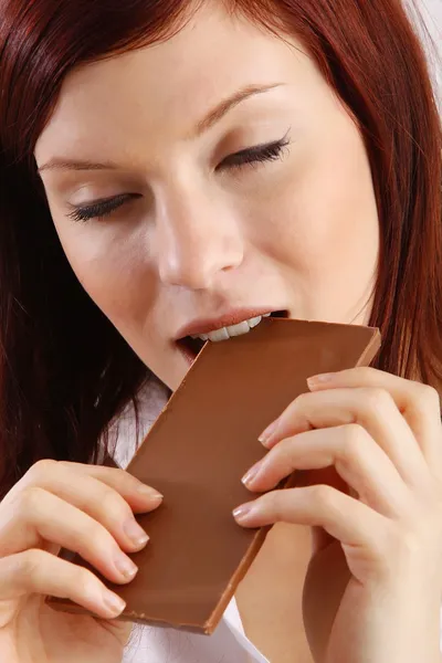 Young beautiful woman with a bar of chocolate — Stock Photo, Image