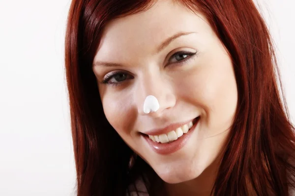 Smiling woman put moisturizer cream on nose — Stock Photo, Image