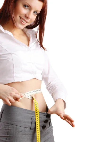 Fit beautiful woman holding measure tape around her stomach. — Stock Photo, Image