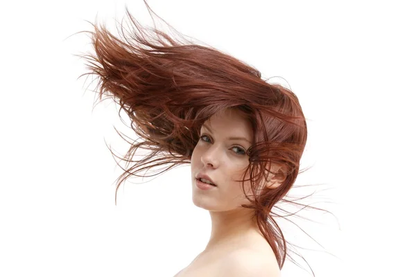 Retrato de uma jovem mulher com o cabelo levemente balançando no vento em um fundo branco — Fotografia de Stock