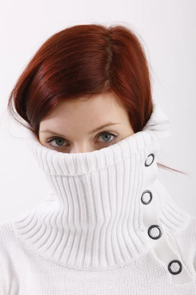 Displeased young woman wearing a high neck sweater, isolated against white background — Stock Photo, Image