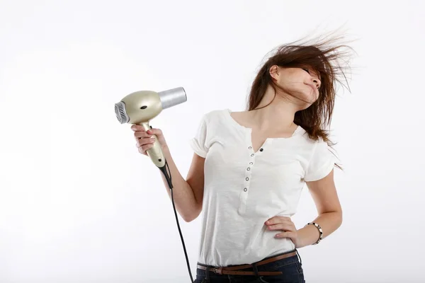 Menina com um secador de cabelo na mão — Fotografia de Stock