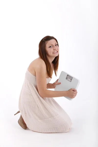 Girl in white dress with weights — Stock Photo, Image