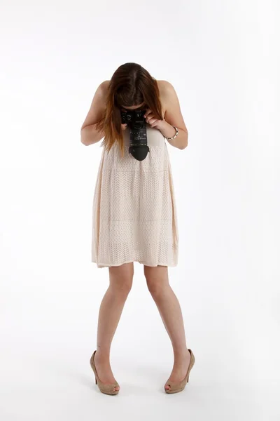 Girl posing in a white shirt with a camera — Stock Photo, Image