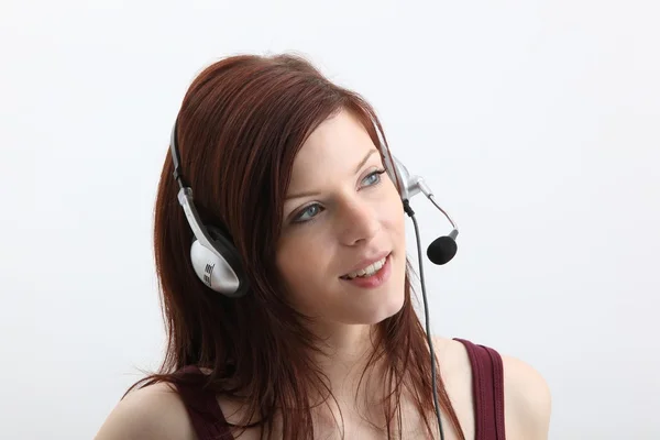 Girl talking on headphones — Stock Photo, Image