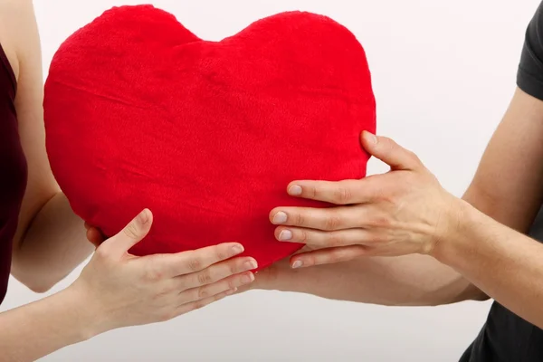 Girl with a heart-shaped pillow — Stock Photo, Image